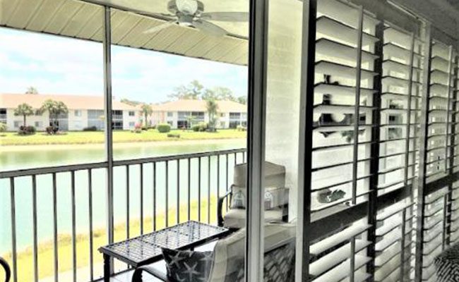 A balcony with a view of the water and golf course.