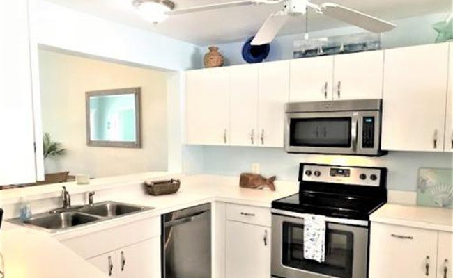 A kitchen with white cabinets and stainless steel appliances.