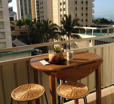 A balcony with two chairs and a table